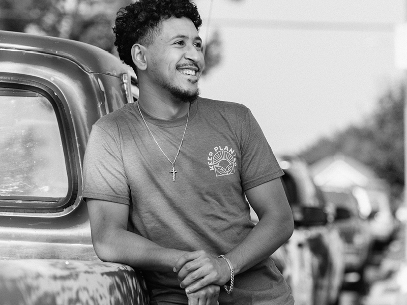Young man wearing a Keep Planted shirt